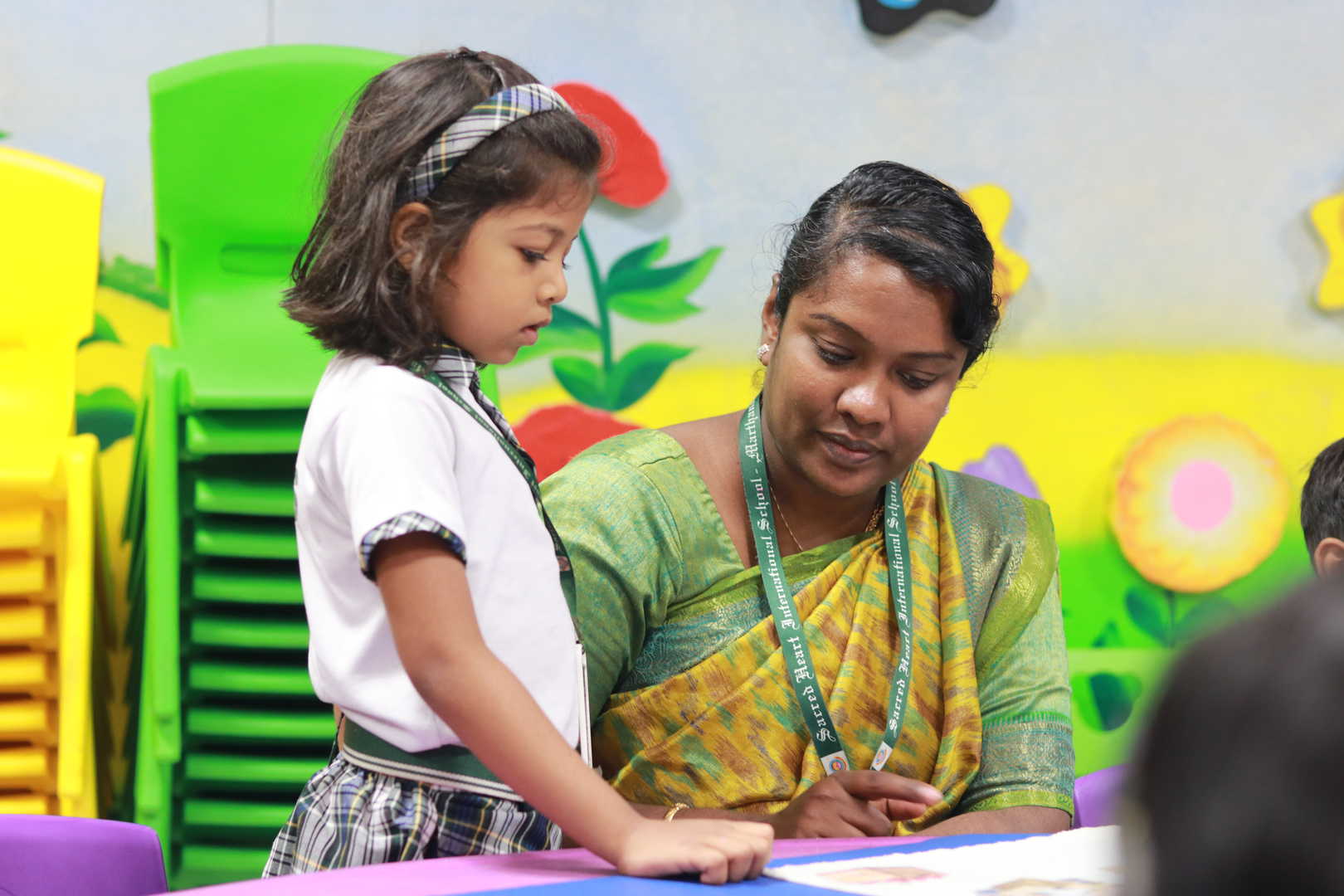 A teacher guiding a child through a Montessori activity
