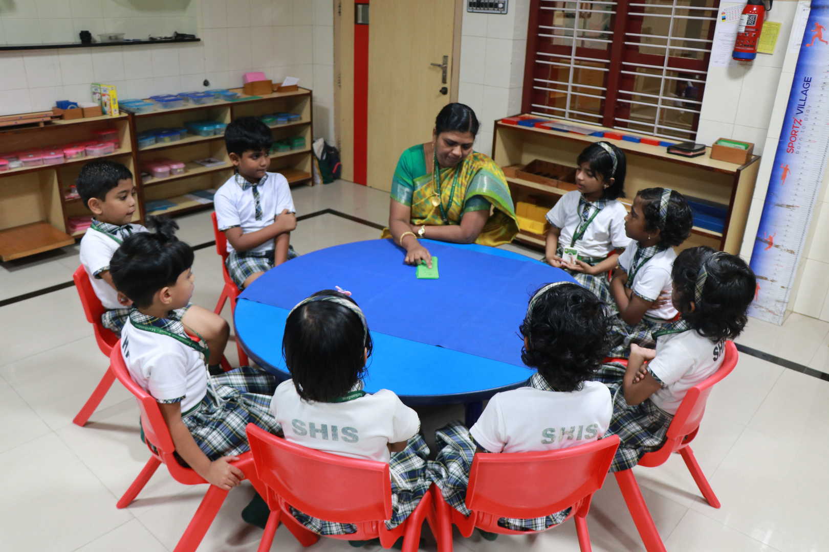 Children gathered around a table in a Montessori activity